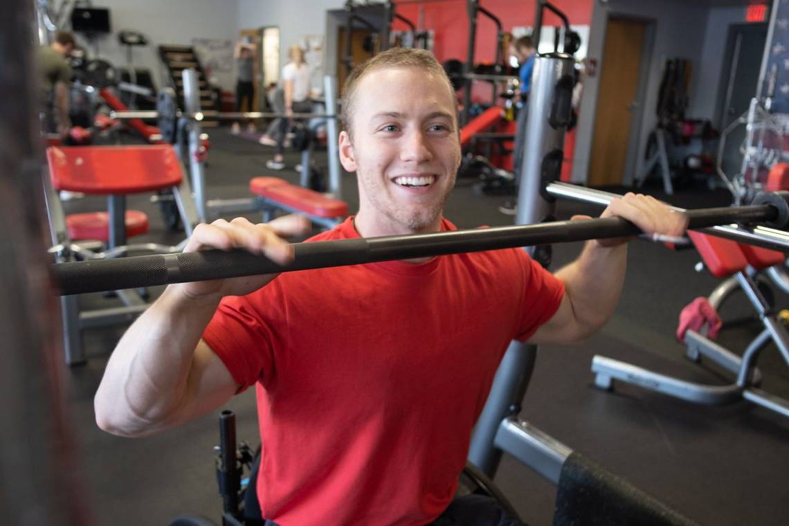 Snap Fitness member Cosmo, smiling at the squat rack