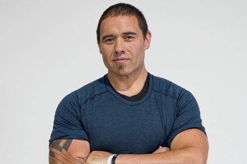 Snap Fitness member Keegan, smiling with arms crossed